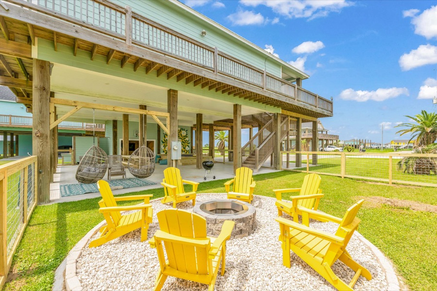 Fire pit with yellow Adirondack chairs